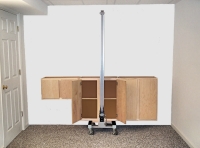MOVE THE ASSEMBLED CABINETS IN FRONT OF THE WALL WITH THE TOOL UNDERNEATH, WHERE THEY ARE TO BE INSTALLED. THE ASSEMBLY SHOULD BE APPROXIMATELY ONE INCH AWAY FROM THE WALL PRIOR TO RAISING THEM INTO POSITION